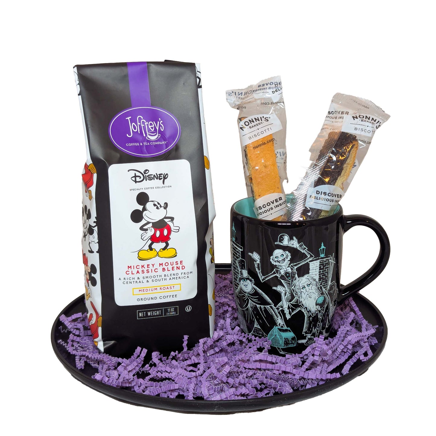 Haunted Mansion themed black coffee mug with biscotti and a black and white bag of Joffrey's Mickey Mouse Classic Blend coffee for Disney vacation gifts