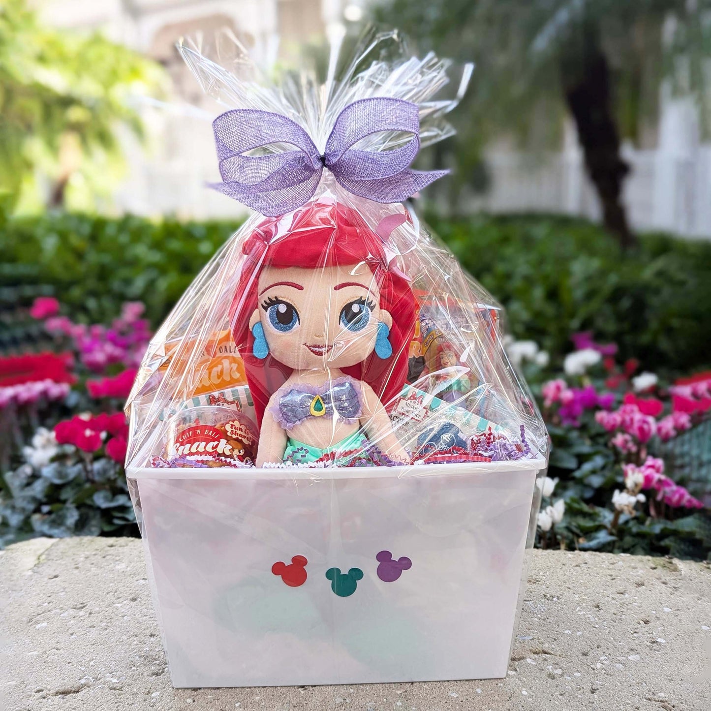 Custom Ariel The Little Mermaid themed gift basket with an Ariel plush toy, sweet and salty snacks, and a collectible PEZ dispenser for Orlando resort delivery