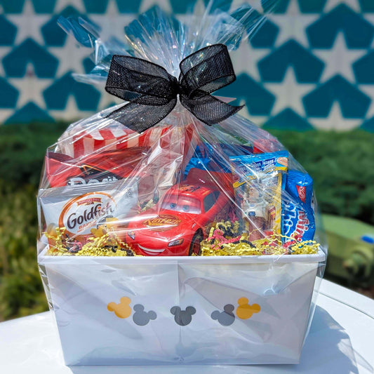 Custom Disney Pixar Cars Lightning McQueen plastic toy gift basket filled with assorted sweet and salty snacks for Orlando resort delivery