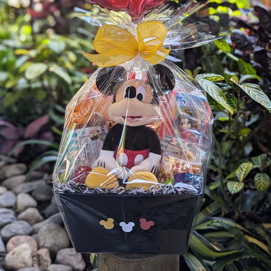 Custom Disney Mickey Mouse gift basket filled with a licensed plush toy and assorted sweet and salty snacks for Orlando resort delivery