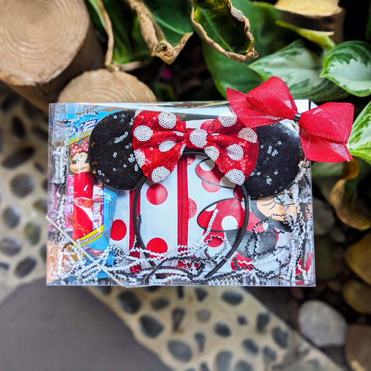 Custom Minnie Mouse gift set featuring a red and black polka dot passport crossbody bag, matching sequined Minnie ears, a Mickey PEZ dispenser, and candies for Orlando resort delivery