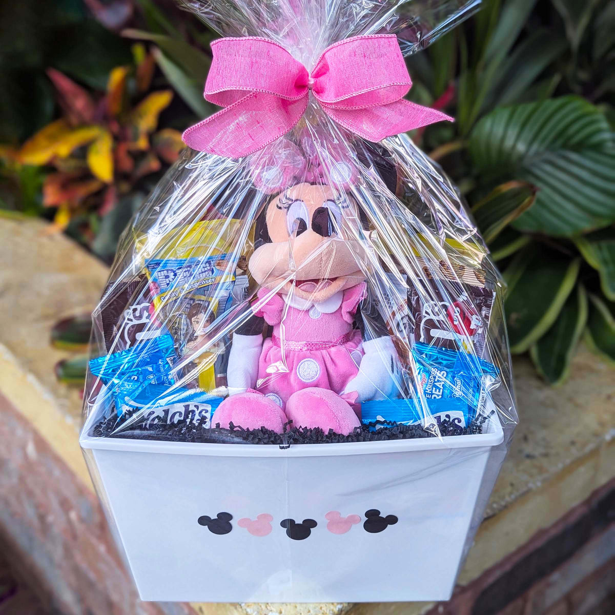 Custom Disney Minnie Mouse gift basket filled with a licensed 14-inch pink plush toy and assorted snacks for Orlando resort delivery