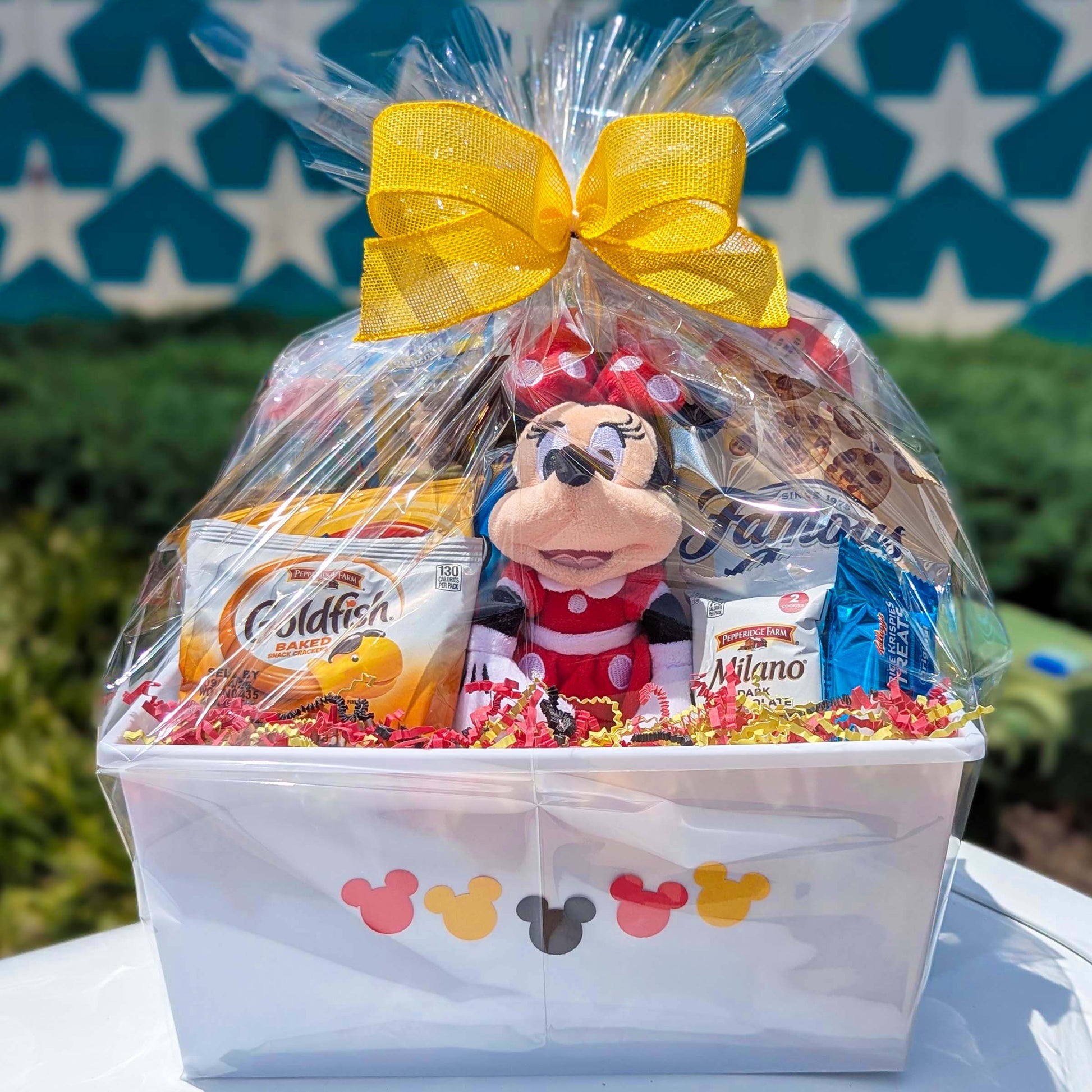 Custom Disney Minnie Mouse gift basket filled with a licensed 8.25-inch red bean bag plush toy and assorted snacks for Orlando resort delivery