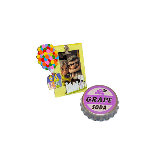 Disney Pixar UP themed picture frame featuring Carl, Ellie, and the balloon house next to a Grape Soda cap tin with grape mints for an Orlando resort gift set