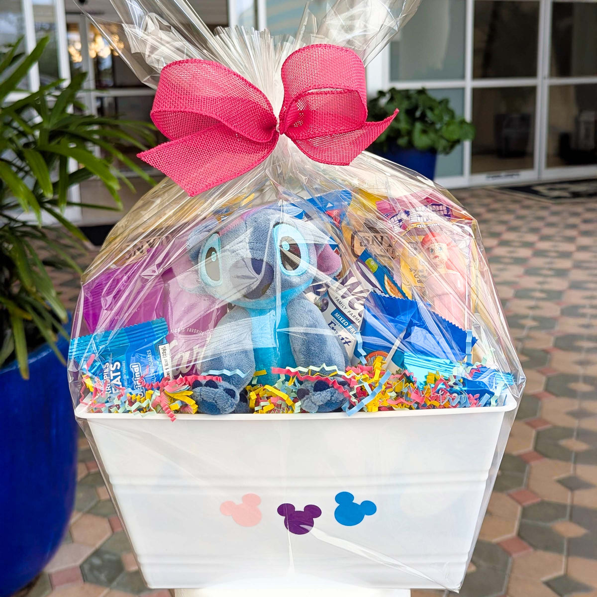Custom Disney Stitch gift basket filled with a 6-inch licensed bean bag plush toy, Rice Krispies Treats, and snacks for Orlando resort delivery