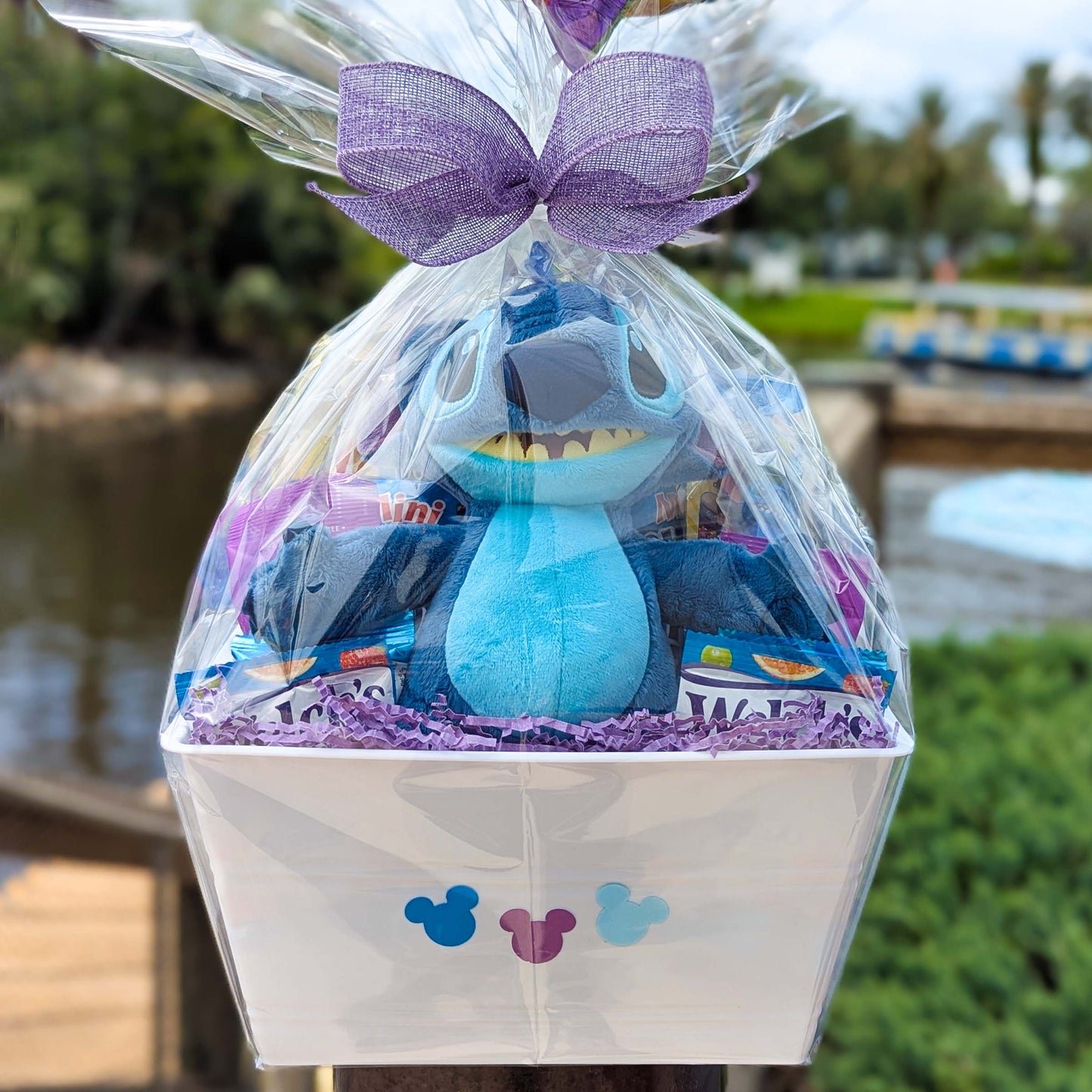 Custom Disney Stitch gift basket filled with an 11-inch licensed Disney Parks plush toy, Welch's fruit snacks, and assorted treats for Orlando resort delivery