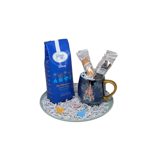 Happiest Sip on Earth gift basket featuring Joffrey’s Disney Resort Blend coffee, a blue castle-themed mug, and biscotti for Walt Disney World area resort delivery