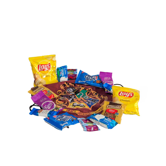 Assorted sweet and salty snacks including chips, cookies, and candy arranged on a licensed Hogwarts drawstring backpack for custom Orlando resort gift baskets