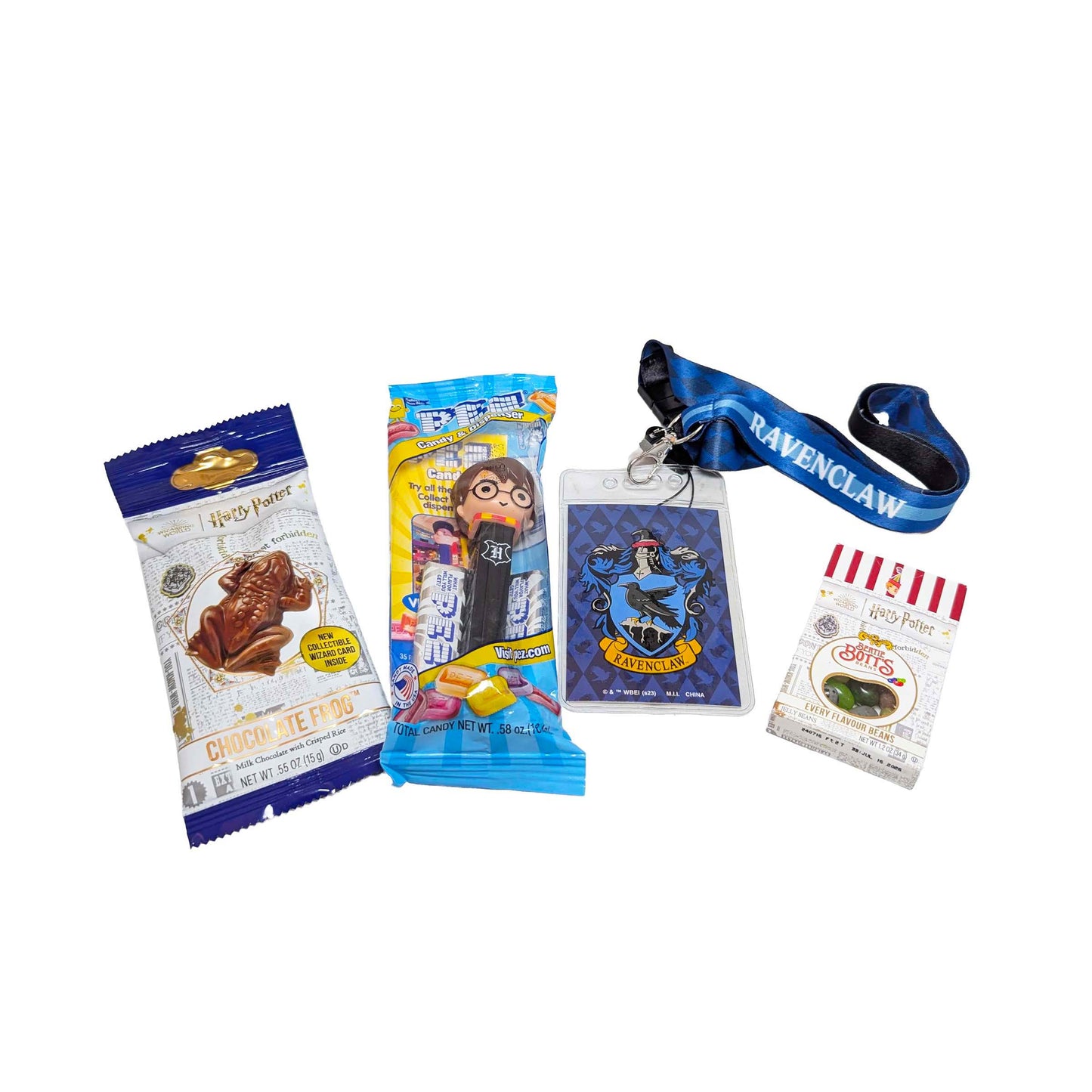 Flat lay arrangement of a Ravenclaw house lanyard, a Chocolate Frog, themed PEZ dispenser, and Bertie Bott's Every Flavor Beans for an Orlando resort gift box