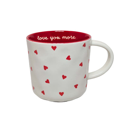White ceramic mug with red heart patterns and "love you more" script, perfect for themed Orlando resort gift baskets