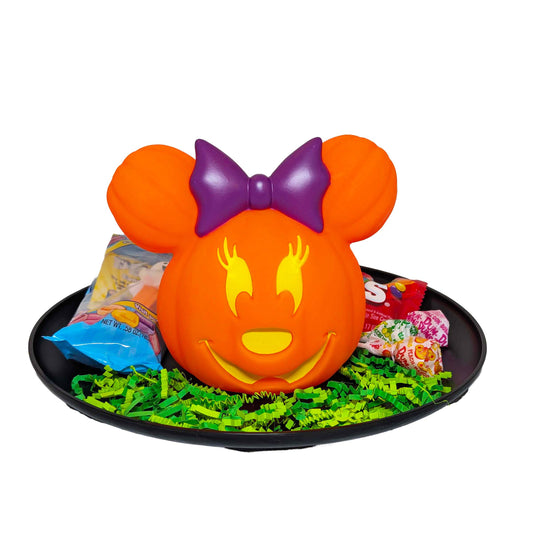 Minnie Mouse light-up Jack-o'-Lantern gift basket filled with Halloween candy on a black tray with green crinkle paper
