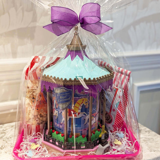 Prince Charming Regal Carrousel refillable popcorn bucket gift basket with Mickey Main Street Kettle Corn wrapped in clear plastic with a purple bow