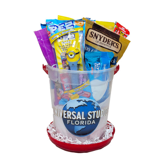 Universal Studios Florida refillable popcorn bucket gift basket filled with sweet and salty snacks, pretzels, and a Minion PEZ dispenser for theme park resort delivery